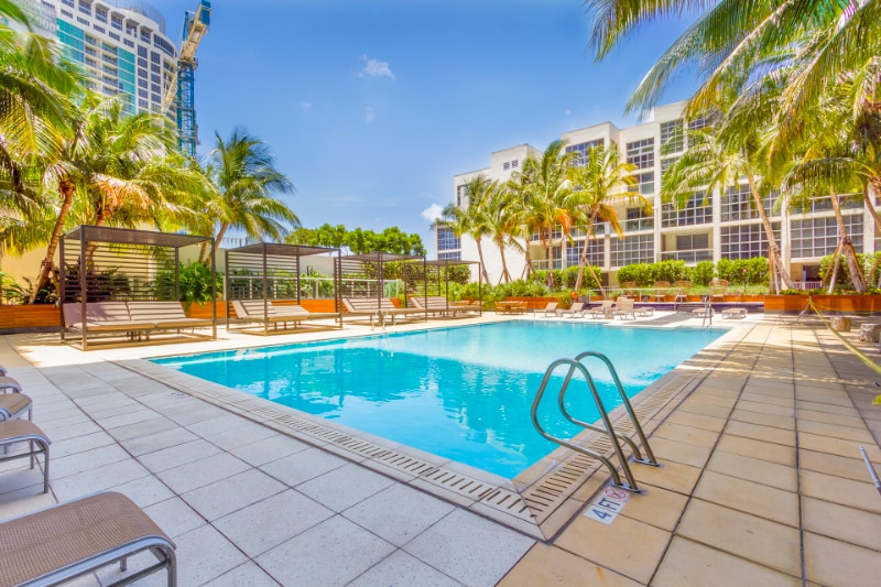 Resort-style swimming pool with tropical landscaping